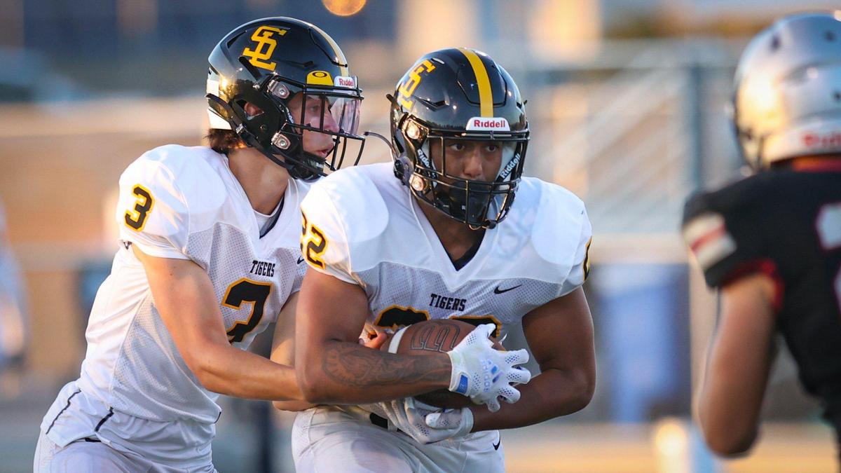 Jace Gomes hands off to Isaiah Hernandez in San Luis Obispo’s 35-0 win over Nipomo in the opening game of the season Aug. 19, 2022.