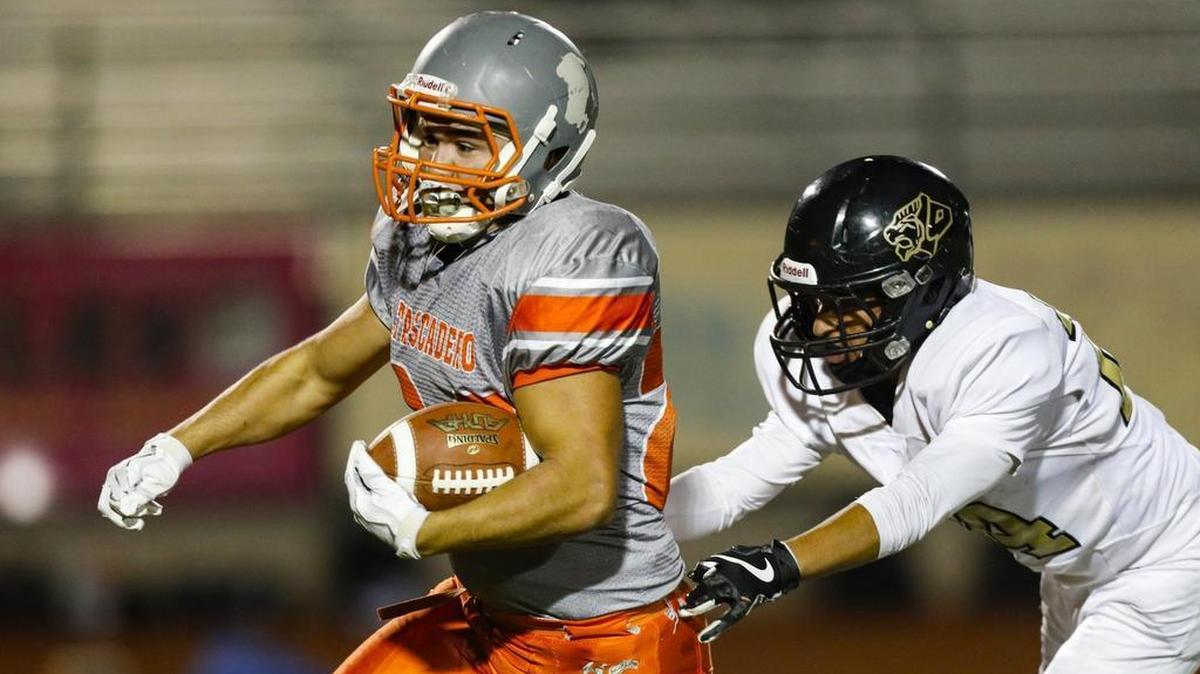 Arik Machado runs as Mikey Moore attempts to tackle. Atascadero hosted San Luis Obispo for football.