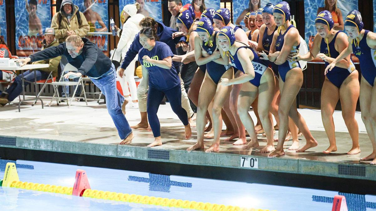 Coaches and the team dive into the pool after Arroyo Grande girls water polo beat Righetti 11-5 on Oct. 30, 2024, to win another Mountain League title.