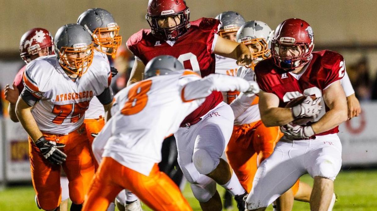 Atascadero High defensive back Zack Quickly closes in to tackle Paso Robles running back Christian Erickson during the Greyhounds’ 31-14 win Friday night.
