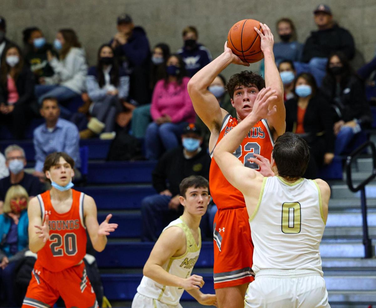 C.J. Bell shoots as David Andrade defends. Mission Prep defeated Atascadero 74-65 in San Luis Obispo Jan.28, 2022.