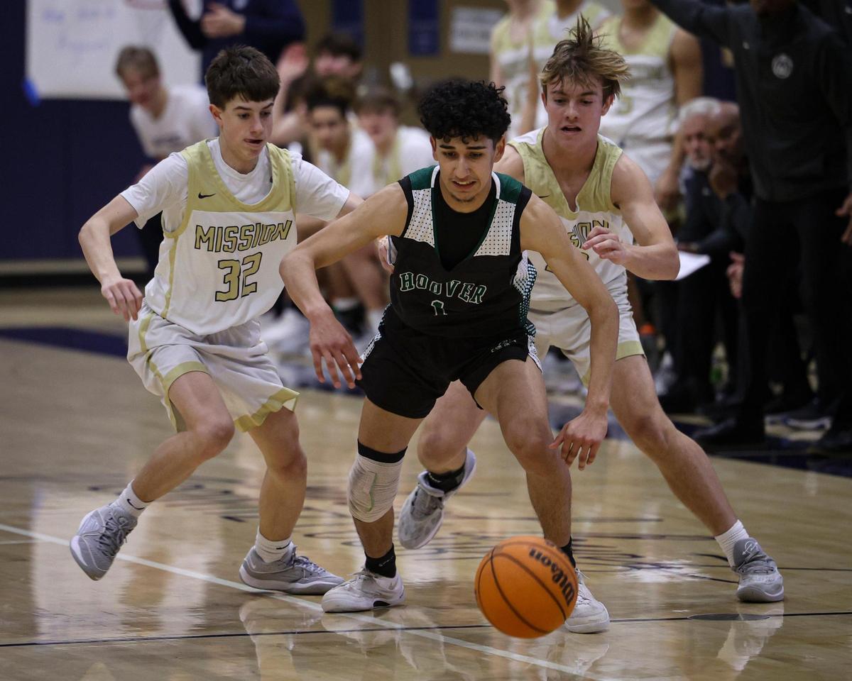 Cesar Juarez is trapped by Brody Miller left, and Brayden Mott. Mission Prep overcame a first half deficit to finish with a win over Hoover of Fresno, 67-56 in a high school basketball playoff Feb. 20, 2024.