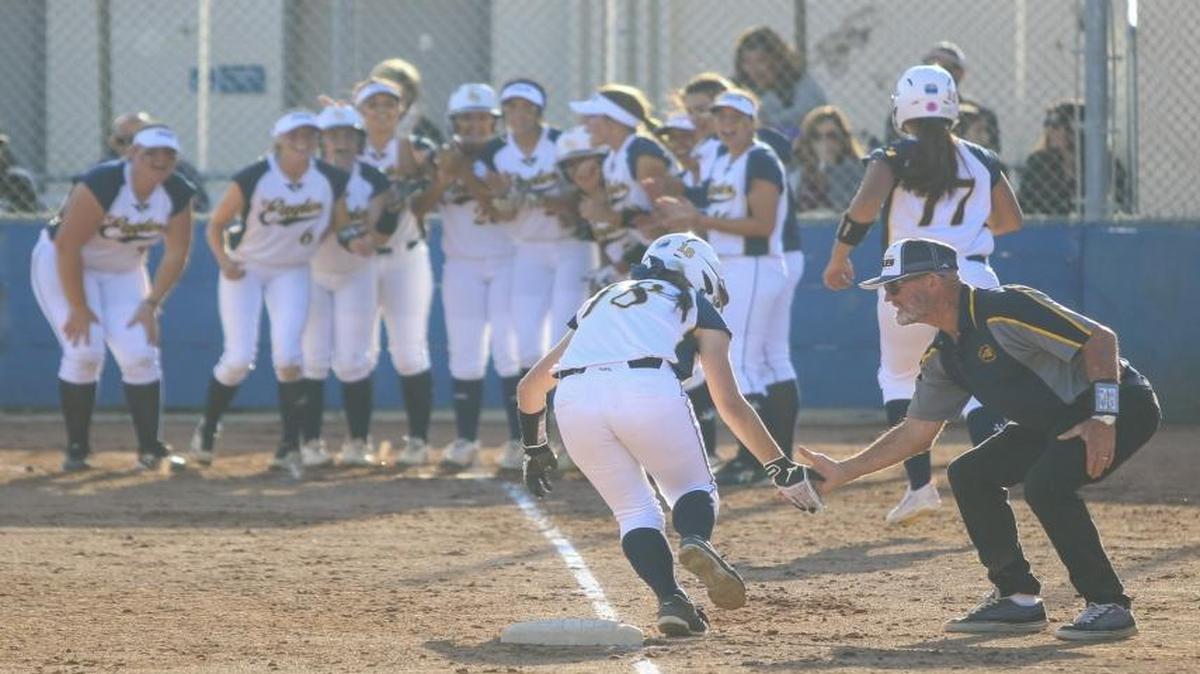 Arroyo Grande’s Bri Girodano celebrates with head coach John Welch follwing a three-run home run in a win over PAC 8 rivals Righetti.