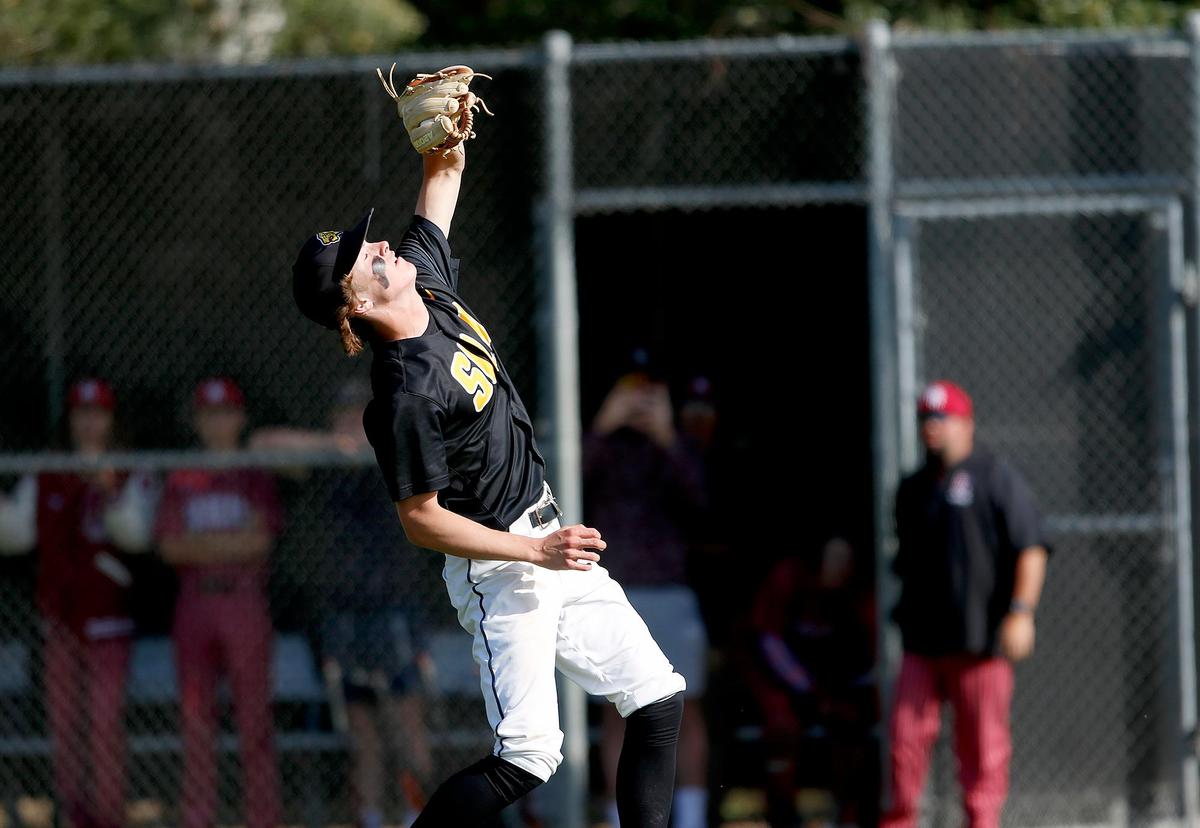 Pitcher Noah Clausen (3) catches an infield pop up. San Luis Obispo Tigers beat Paso Robles High school 12-5 at Taylor Field in San Luis Obispo on Friday.