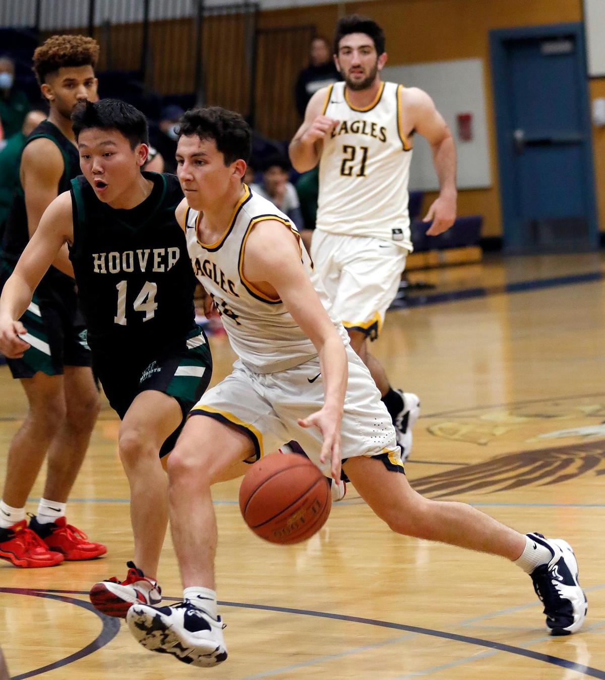 Arroyo Grande’s boys basketball team lost to Hoover of Fresno 68-63 in a first round CIF-Central playoff game. Lucas Juarez dribbles under pressure from Fresno player.