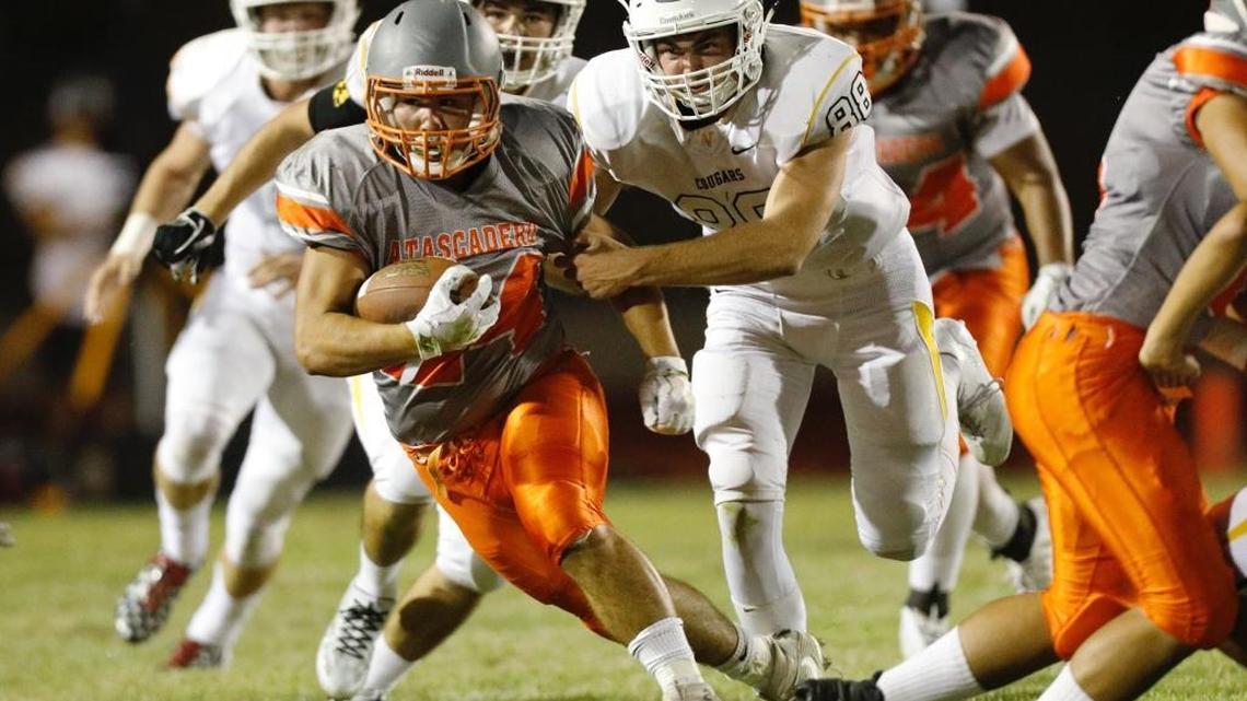 Atascadero High School football’s Arik Machado runs the ball Friday night in the Greyhounds’ nonconference matchup against Ventura.
