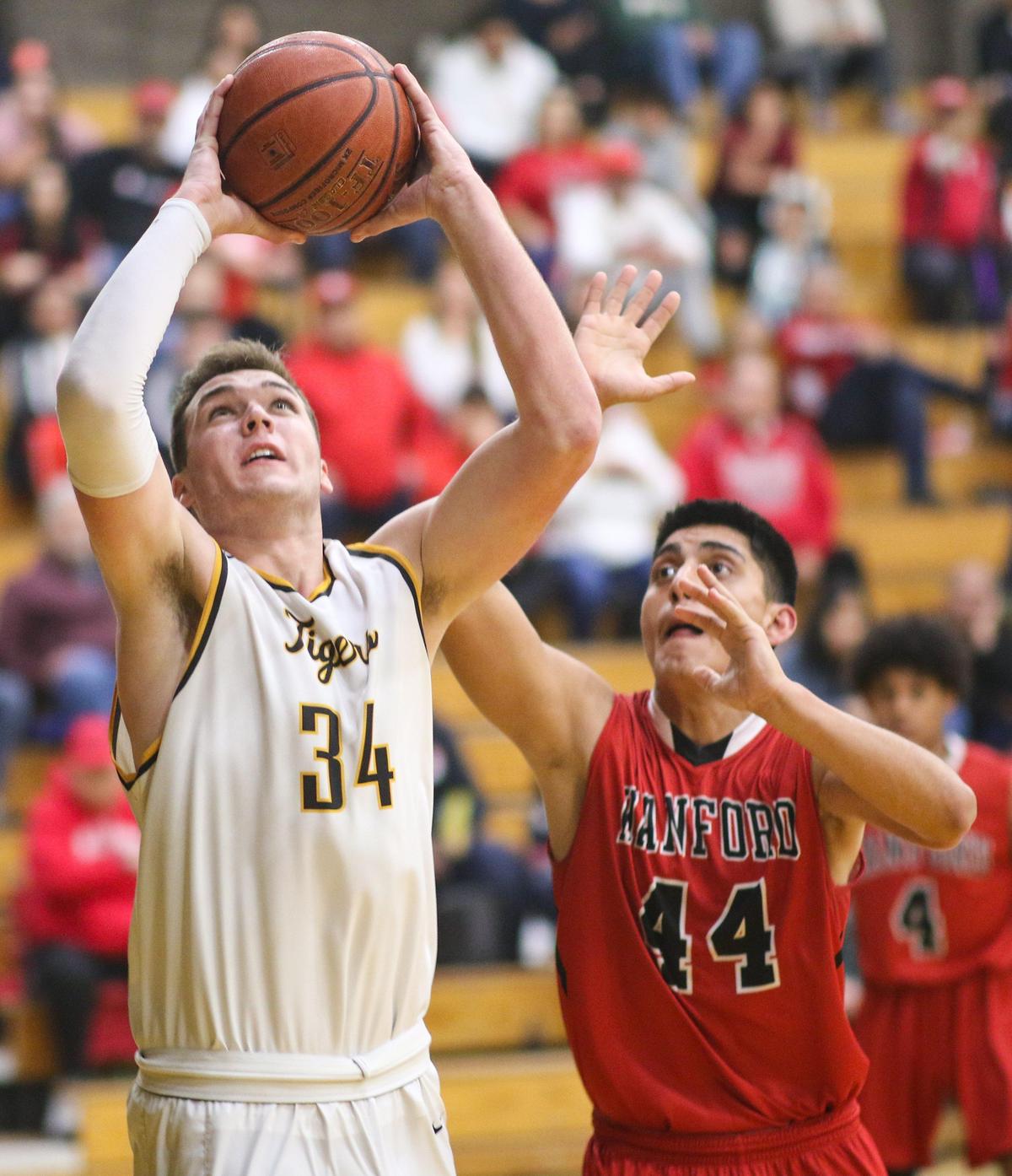 Thomas Cole shoots as Cristian Sotelo defends. San Luis Obispo hosted Hanford in playoff basketball.