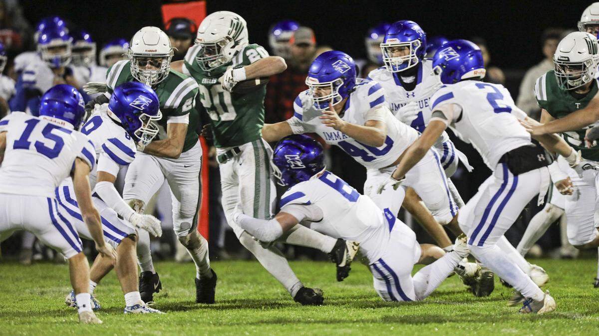Tyler Cunningham follows a block by Colby Sims. Immanuel beat Templeton 48-7 in the CIF Central Section Div. iV Championship on Nov. 21, 2025.