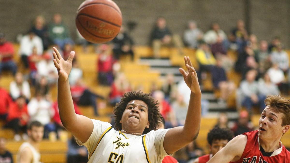 Christian Jones rebounds as Austin Blomquist is at right. San Luis Obispo hosted Hanford in playoff basketball. David Middlecamp 2-20-2020
