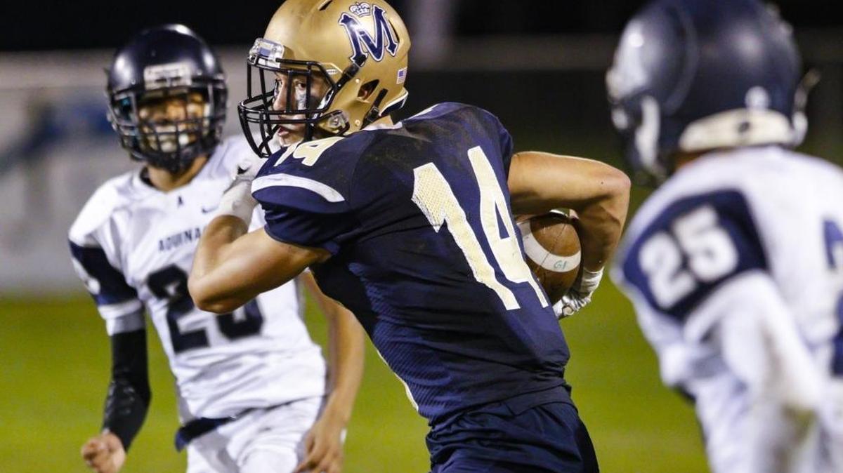 Patrick Miller of Mission Prep runs after catch against Aquinas in a playoff football game.
