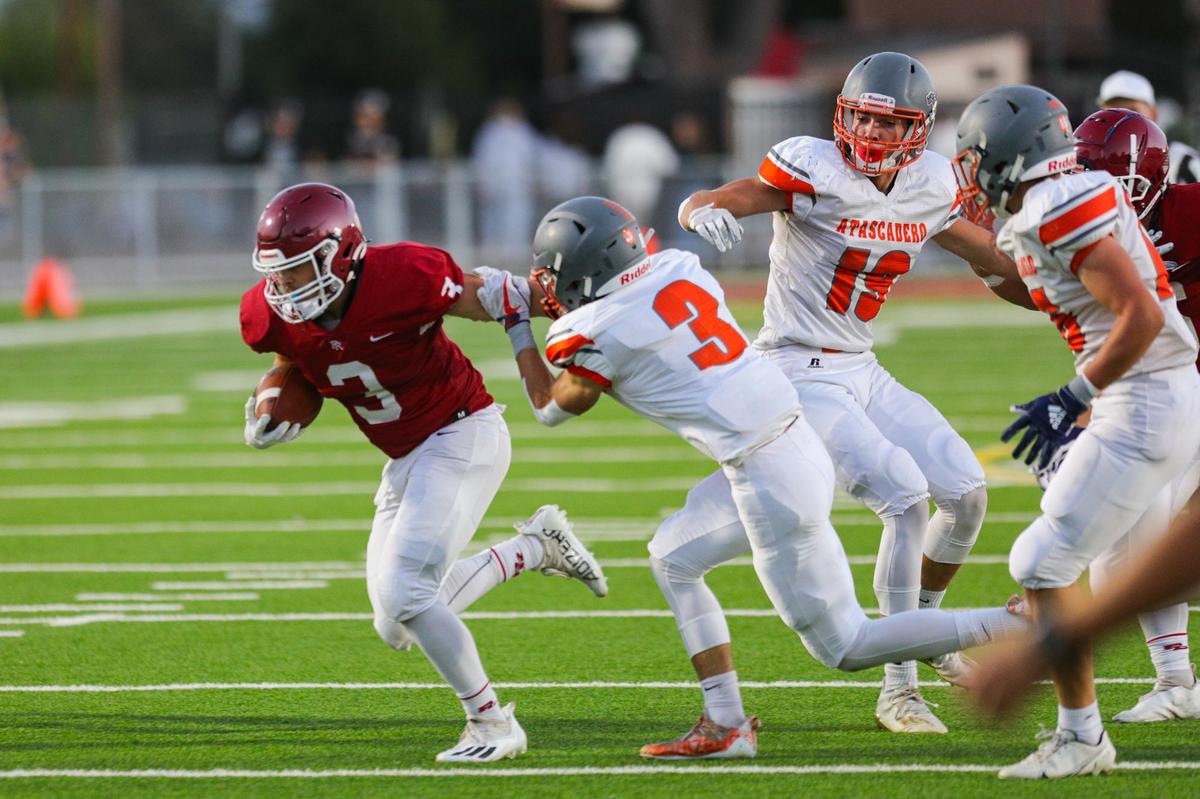 Jake Morones runs pursued by Cole Tanner. Paso Robles hosted Atascadero in a football game at War Memorial Stadium.