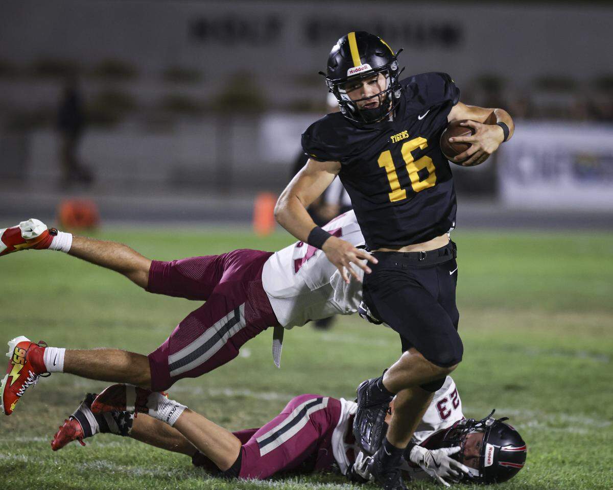 Zion Hegg eludes the Titan defense. San Luis Obispo beat Nipomo 22-16 on Sept. 12, 2025.