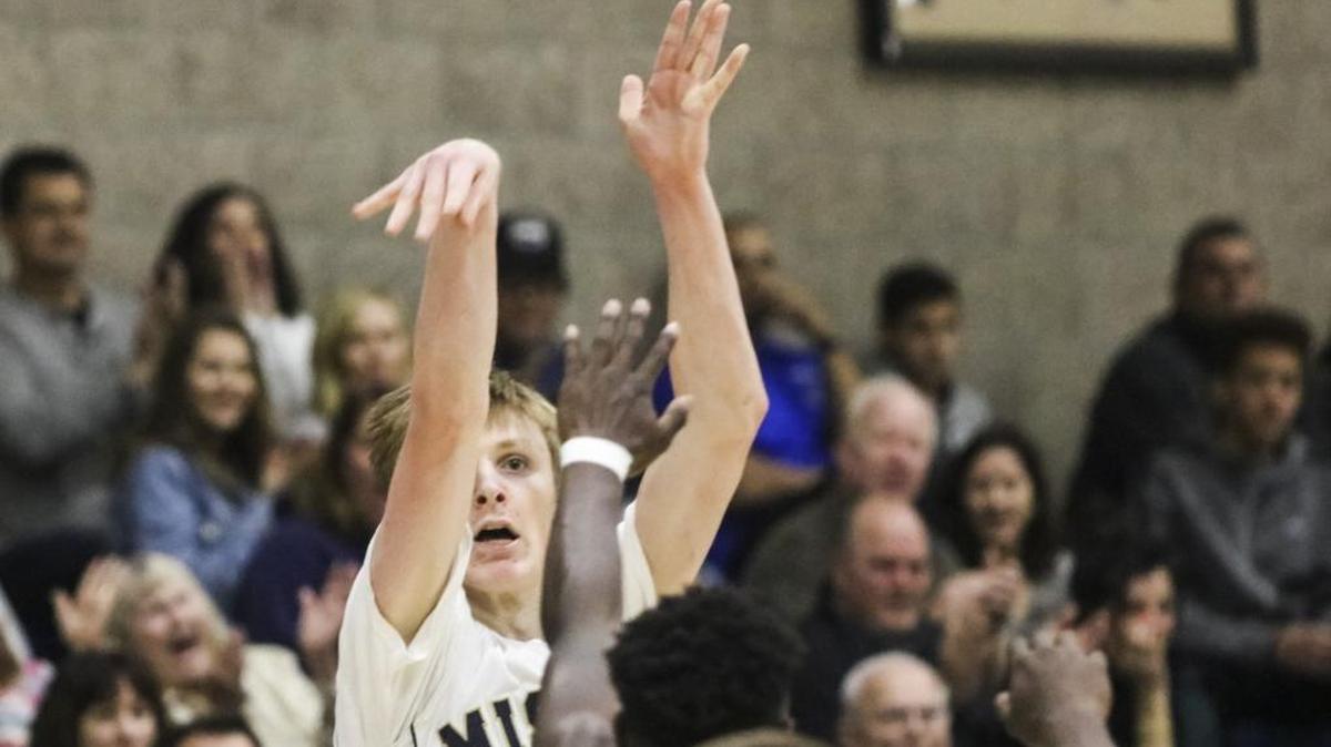 With a hand in his face, Mission Prep junior Kyle Colvin banks home a 3-point shot against St. Joseph.