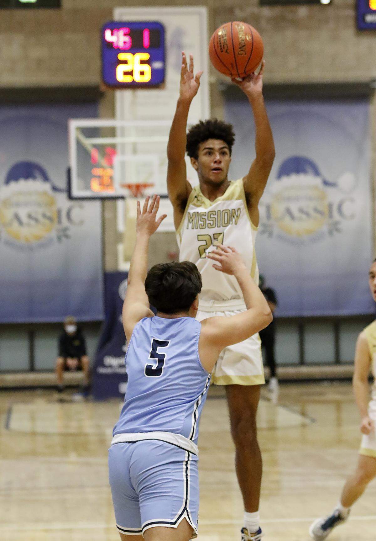 J.J. Howard (23) of Mission Prep shoots over the Saugus’ Adrian Salazar (5) in The Mission Prep Classic basketball tournament.