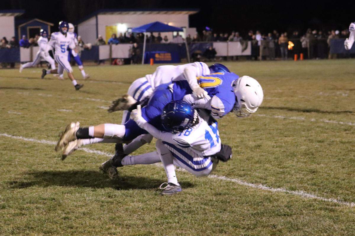 Morro Bay defenders team up for a tackle.