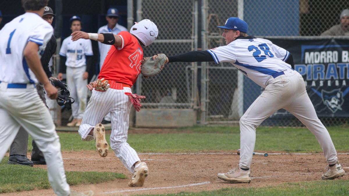 Damon Mitchell is tagged out at home, after a rundown by Evan Davis. Atascadero won 6-4 in a baseball game against Morro Bay High School May 1, 2025.