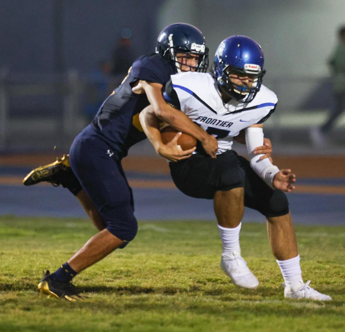 Kaden Tynes grabs Vincent Ioga and drops him for a safety. AG High opened its 2021 fall season against Frontier of Bakersfield.