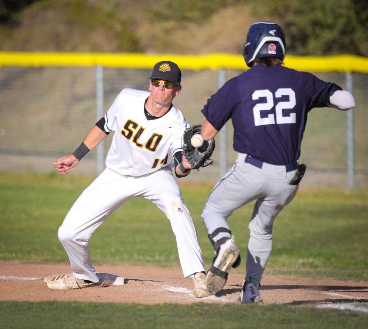 Firstbaseman Max Templin fields a throw and tags Judah Hill. San Luis Obispo won 3-1 over Arroyo Grande in a baseball game in SLO May 12, 2022.