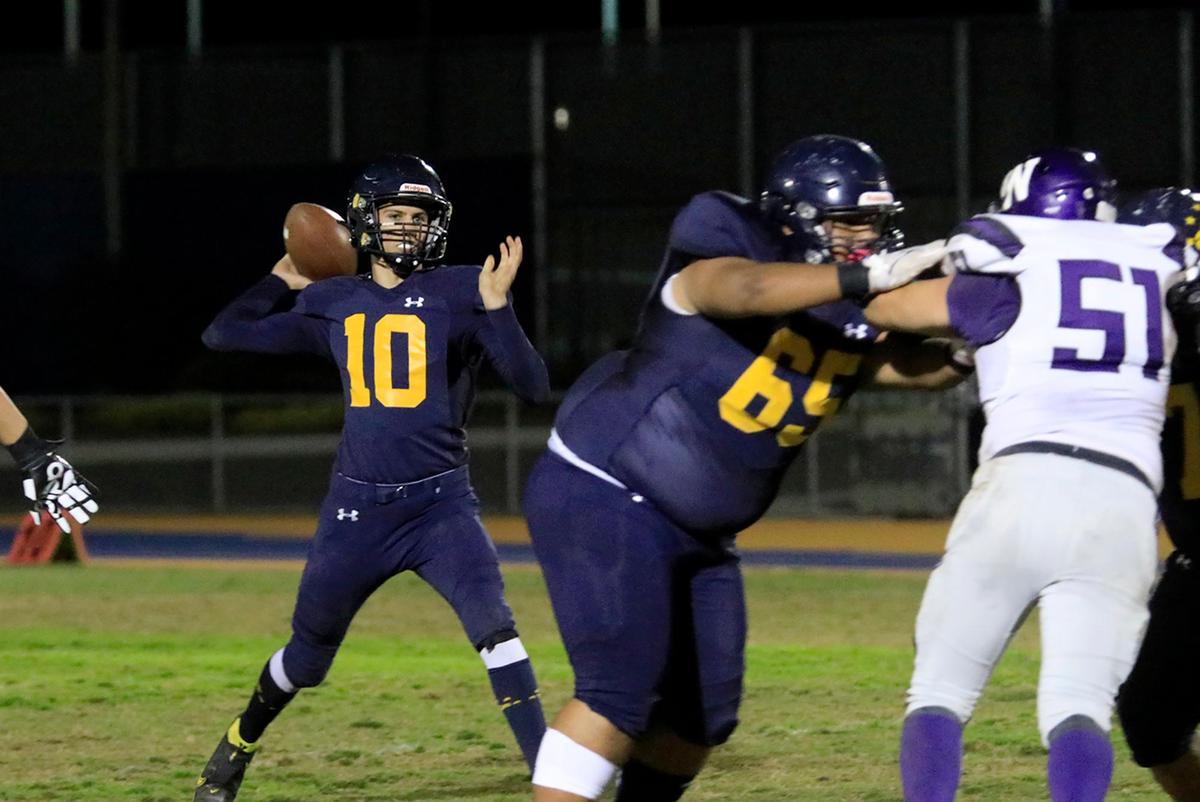 Eagle’s QB Max Perrett (10) gets ready to pass behind a block by Devin Lewis (65). Arroyo Grande lost 52-32 to the Washington Union High Panthers of Fresno in the CIF-Central Section playoffs on Nov. 12, 2021.