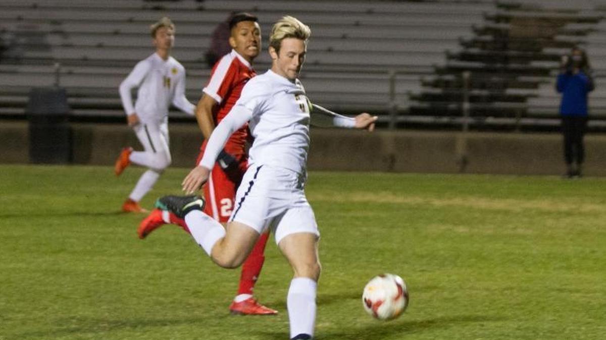 SLO High's Branden Dolezal scores the first of his two goals as Santa Maria's Grebil Aguilar looks on in a nonconference game Wednesday night in San Luis Obispo.