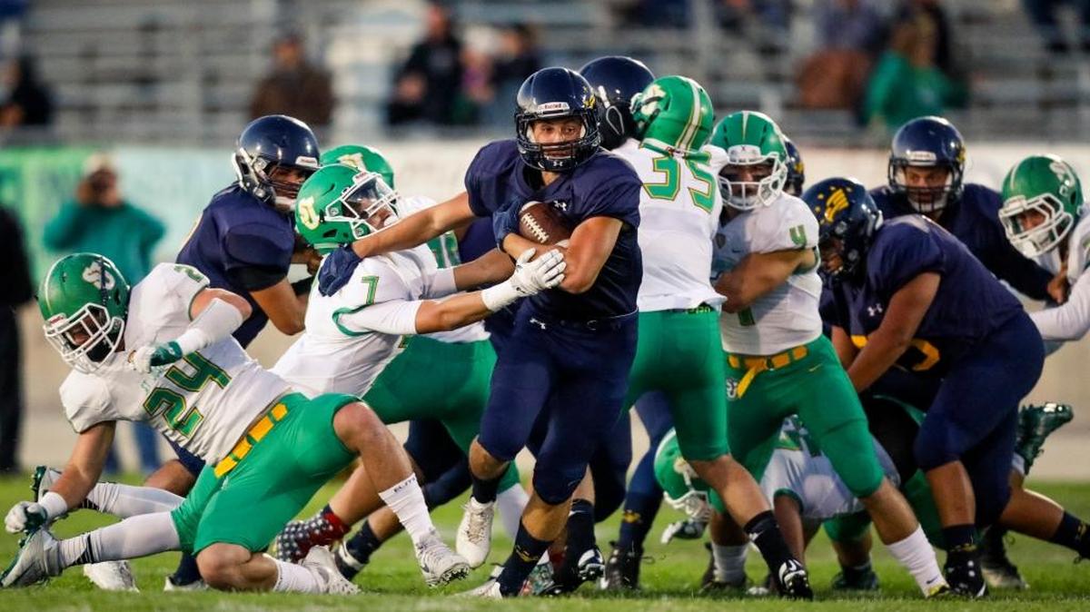 Arroyo Grande junior running back James Gilmet sheds a defender as Arroyo Grande High football hosts St. Josephs in a non-league game. Photo by Joe Johnston 09-22-17