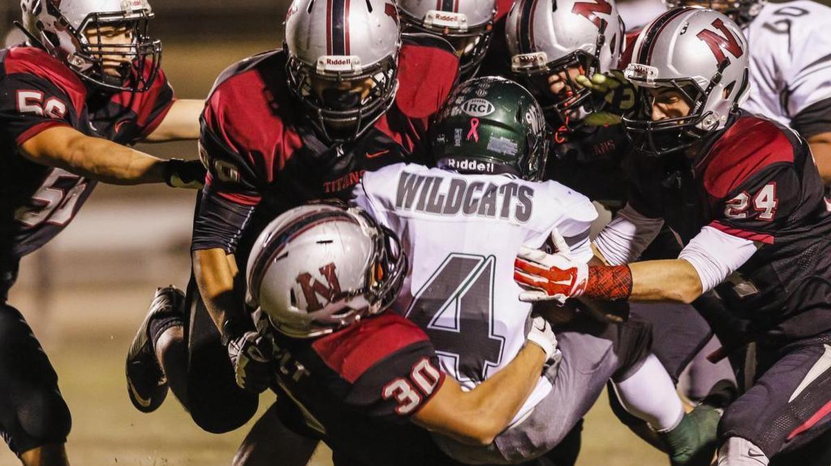 Nipomo High’s defense swarms to tackle Twentynine Palms running back Beayahn Carrillo during Friday’s playoff game.
