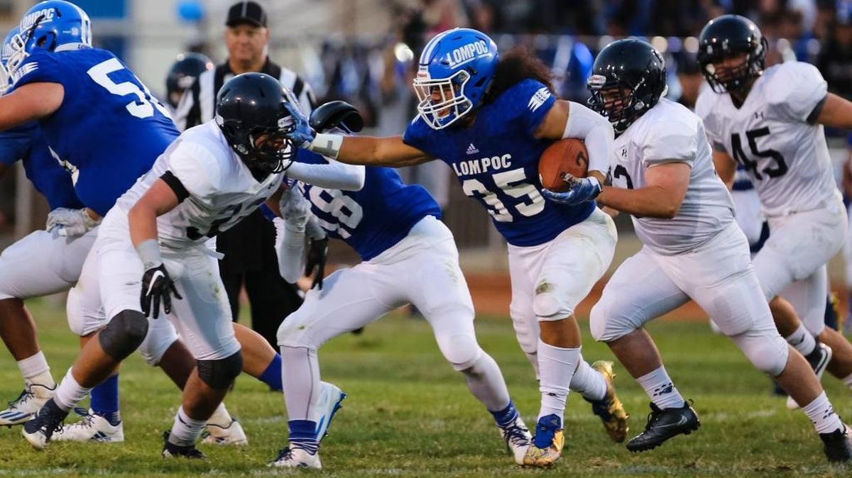 Lompoc running back Toa Taua stiff arms Arroyo Grande linebacker Jack Ventura in the first game of the 2016 season.