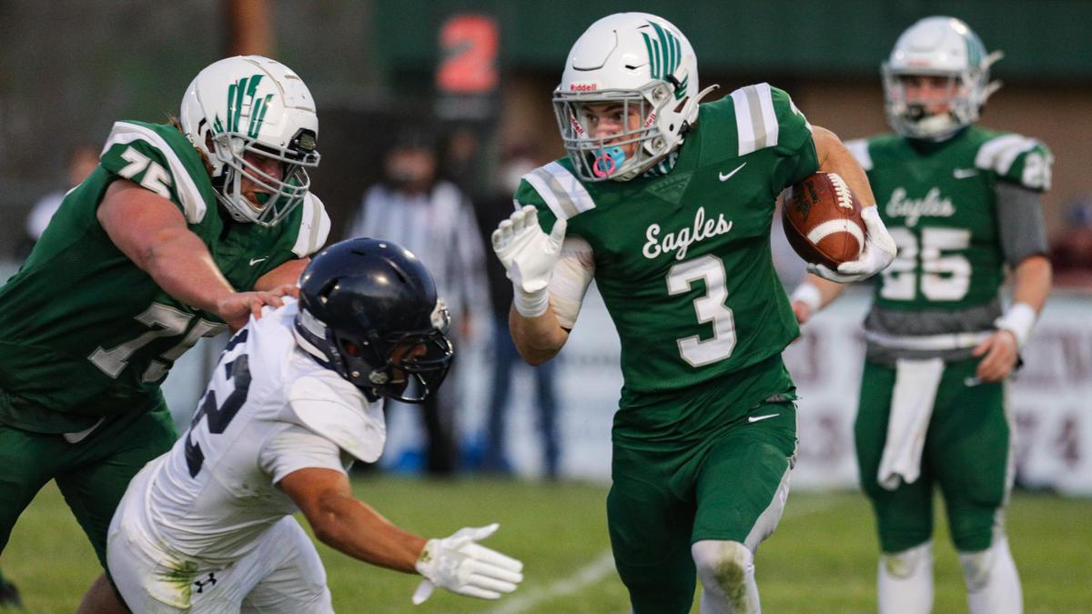 Kale Loppnow runs for Templeton as Chase Richards blocks at left. Vincent Diaz fought through the block to make the tackle. Templeton High School hosted Arroyo Grande in a battle of the Eagles football teams.