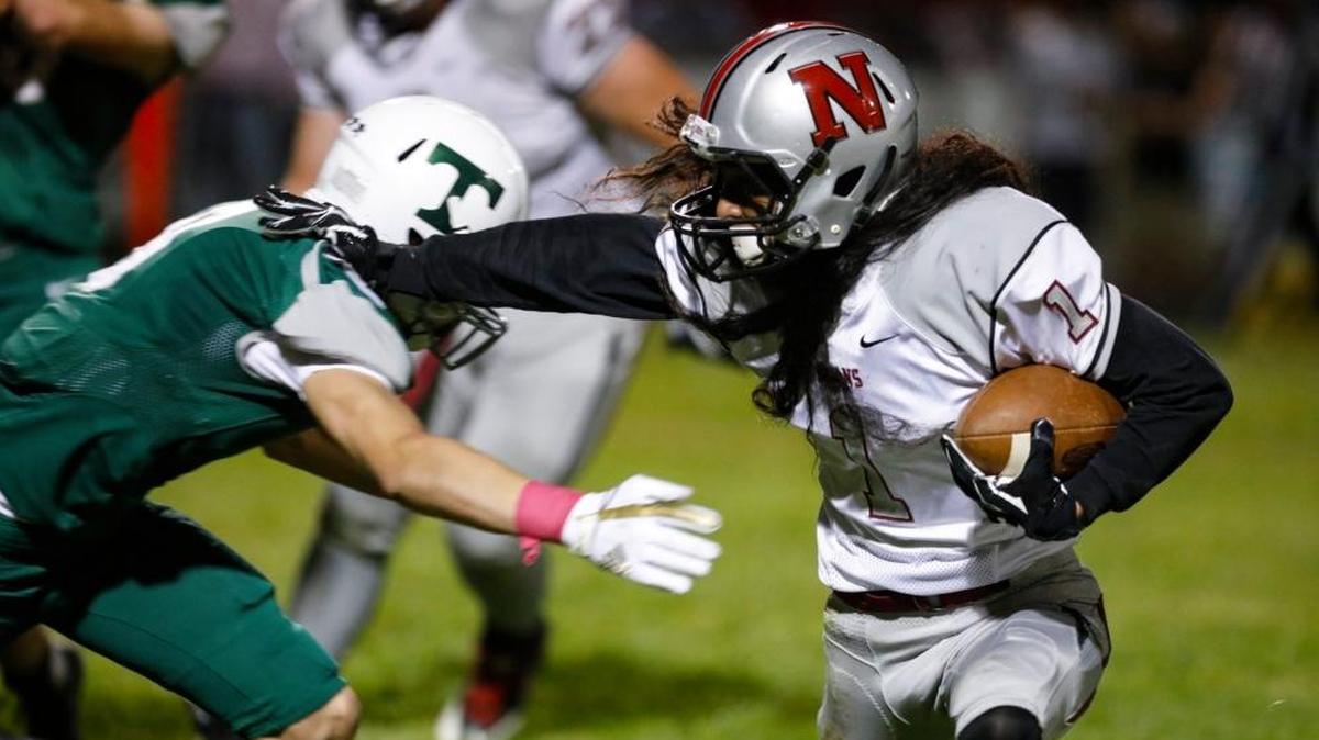 Nipomo senior Jedu Matautia-Reyes stiff arms a Templeton defender during a shut out win to open the Northern League season.