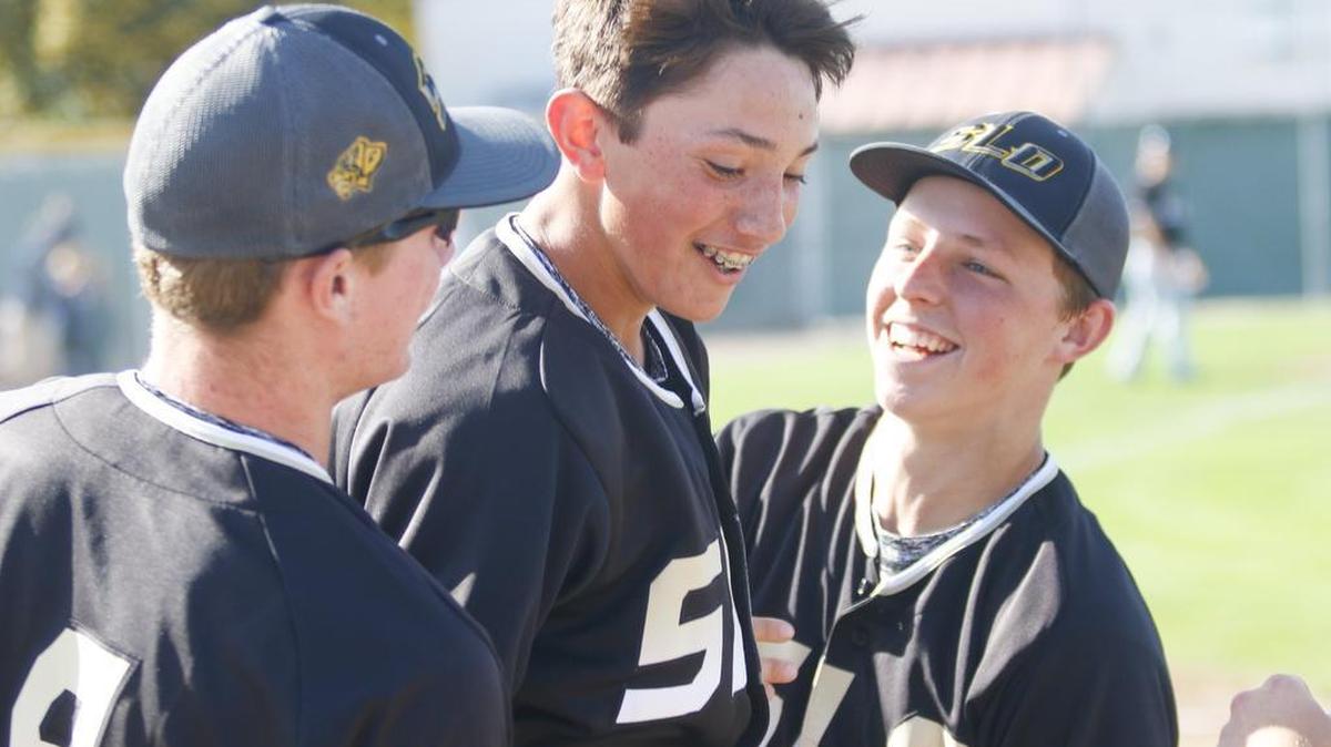 Brooks Lee (center) celebrates scoring a run. Will Compton is at left and Cooper Benson right. Arroyo Grande hosted San Luis Obispo High School for baseball.