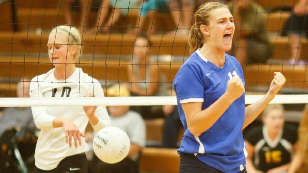 Emily Sonny (right) of Arroyo Grande high school celebrates a point over San Luis Obispo for girl's Volleyball. David Middlecamp 9-24-2015