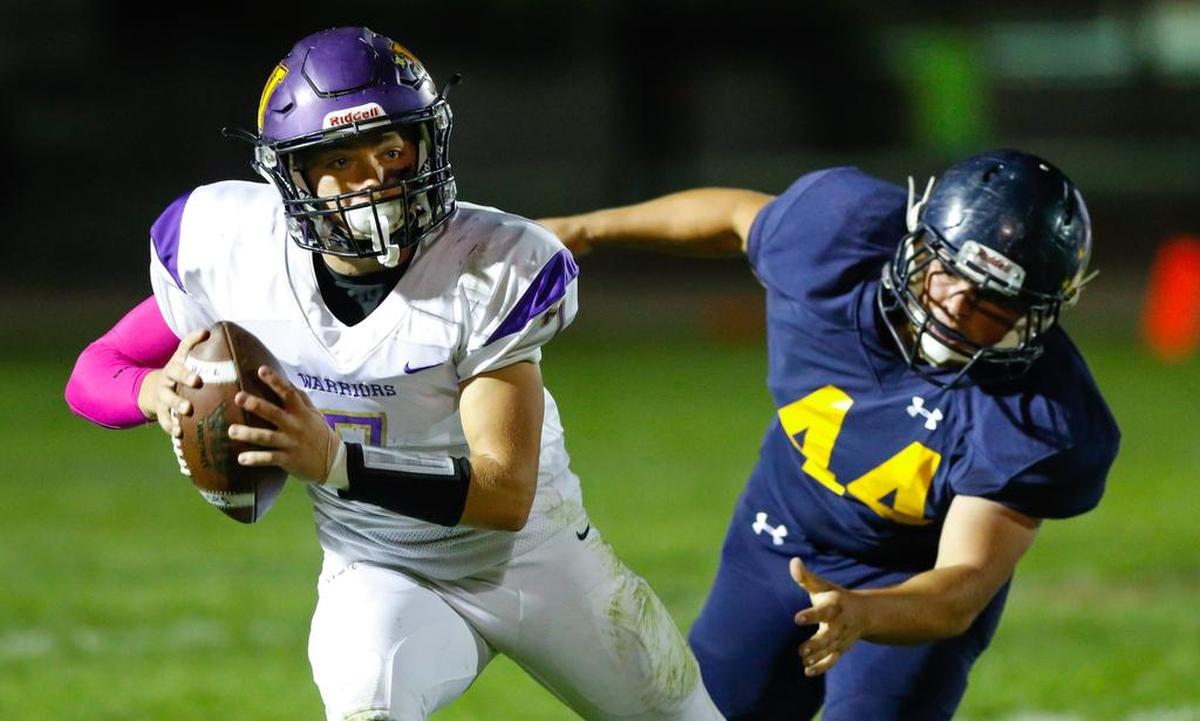 Arroyo Grande High School’s Hunter Collins pursues Righetti quarterback Brandon Giddings in a Mountain League game Friday night.
