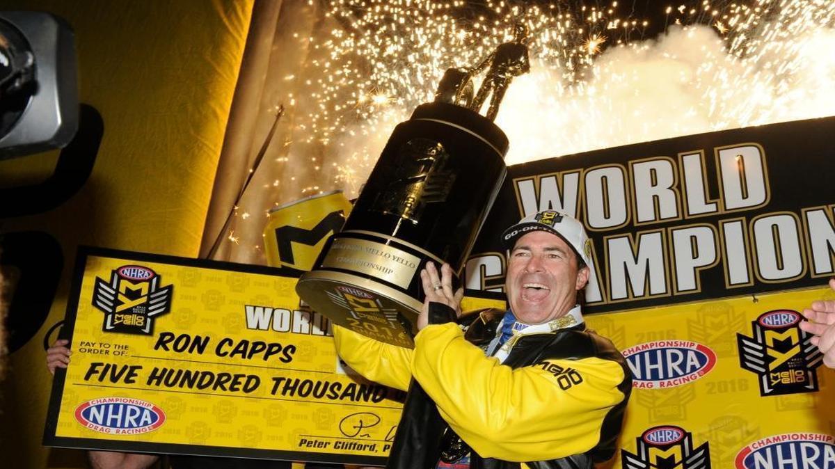 In this photo provided by the NHRA, Ron Capps celebrates his first NHRA Funny Car drag racing championship, Saturday, Nov. 12, 2016, in Pomona, Calif. Capps clinched the title after qualifying with a 92-point lead over his closest opponent, teammate Matt Hagan.