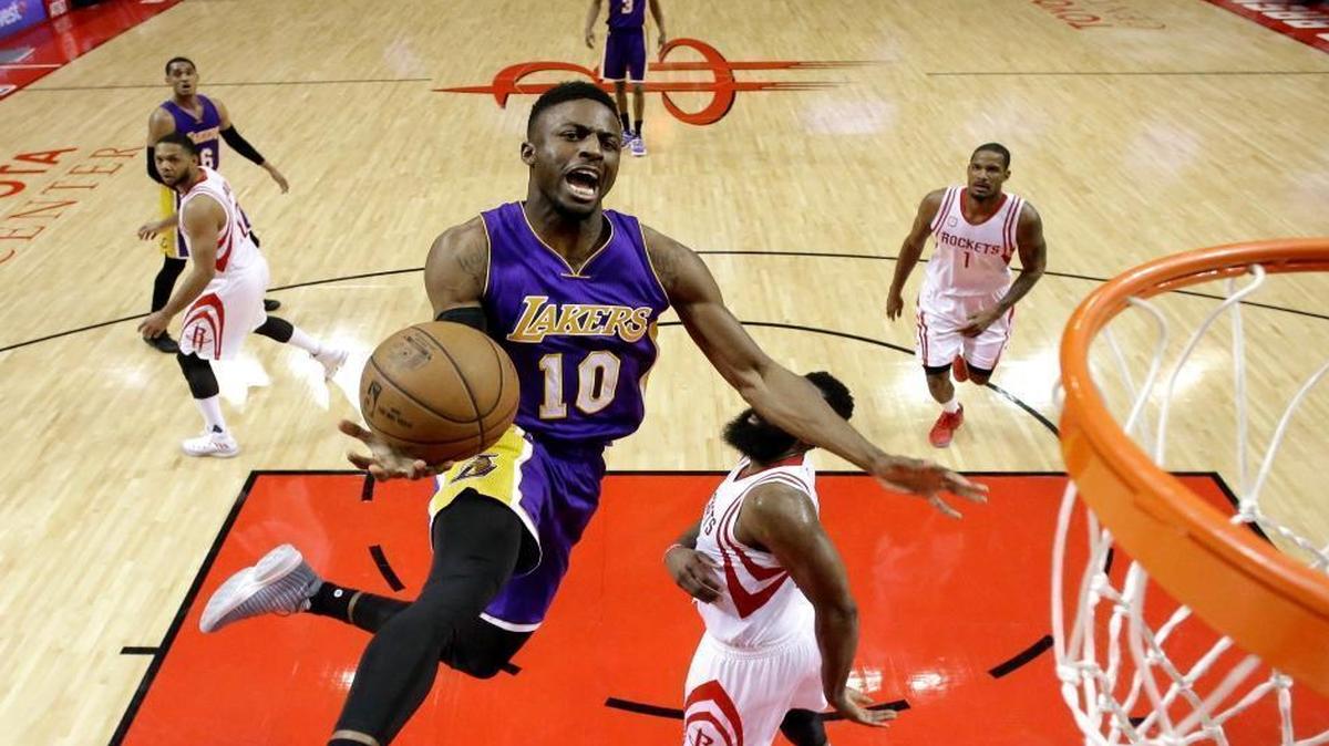 Los Angeles Lakers' David Nwaba (10) goes up for a shot as Houston Rockets' James Harden, right, defends during the second half of an NBA basketball game Wednesday, March 15, 2017, in Houston.