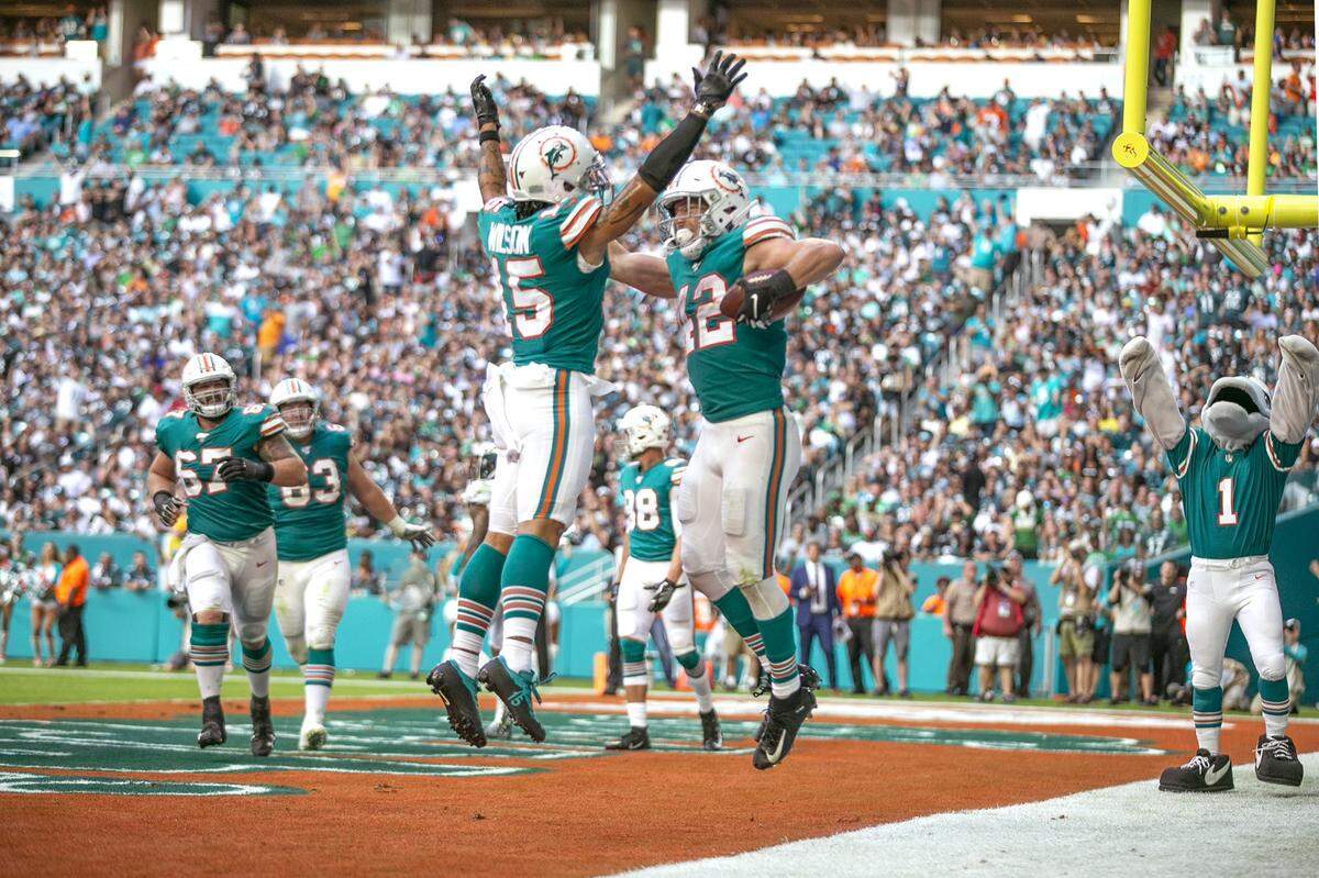 Miami Dolphins running back Patrick Laird (42) celebrates with wide receiver Albert Wilson (15) after Laird scored his first NFL touchdown in the fourth quarter at Miami’s Hard Rock Stadium, Sunday, Dec. 1, 2019. The Dolphins won, 37-31. Laird enters his third NFL season this year.