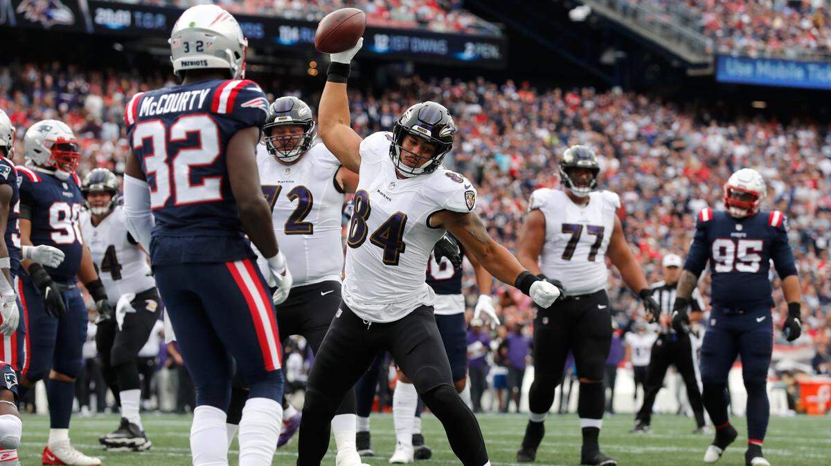 Baltimore Ravens tight end Josh Oliver (84) celebrates his touchdown as New England Patriots safety Devin McCourty (32) looks on in the second half of an NFL football game, Sunday, Sept. 25, 2022, in Foxborough, Mass.