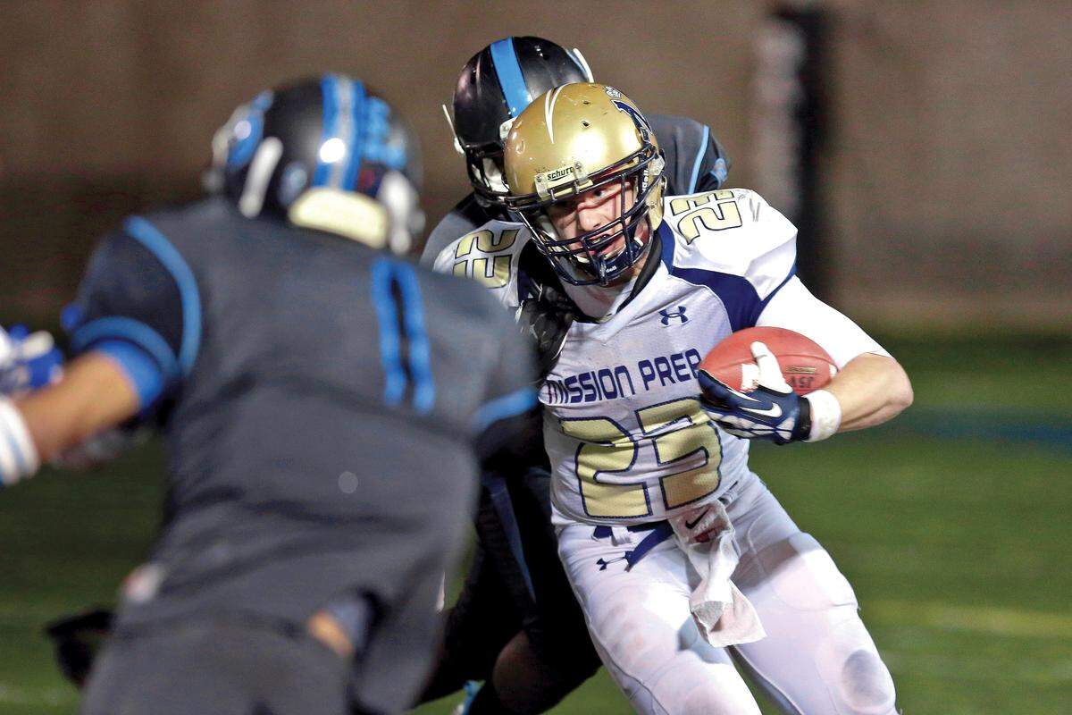 Mission Prep’s running back Patrick Laird #23 is tackled as he carries the football against Salesian High School during the first half of the CIF-SS Northeast Division Championship between Mission Prep High School and Salesian High School at Salesian High School on Saturday, Dec. 7, 2013 in Los Angeles, Calif. Photo by Patrick T. Fallon