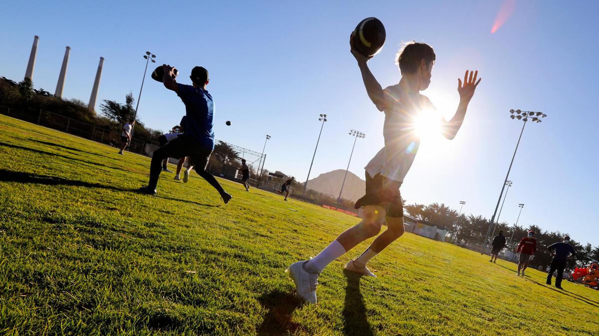 Quarterbacks run passing drills at a park in Morro Bay. Morro Bay High football coach Jake Goossen-Brown has formed a new club football team to play 7-man touch football to replace a season lost to coronavirus. This image won fifth place for best sports feature photo.