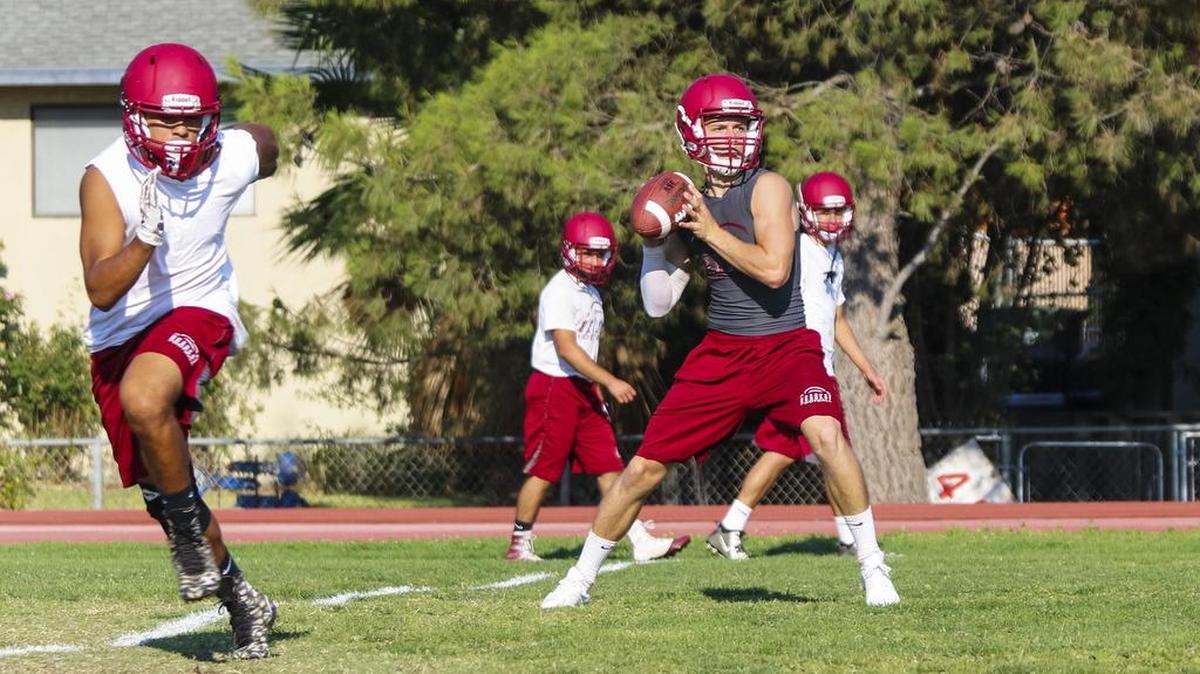 New Paso Robles High quarterback Steven Schouten throws a pass during practice Aug. 18.