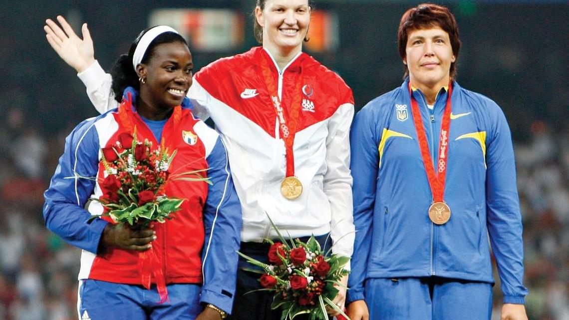 Gold medalist Stephanie Brown Trafton, center, silver winner Yarelys Barrios, left, and bronze winner Olena Antonova stand together during an awarding ceremony for the women’s discus at the Beijing Olympics in 2008.