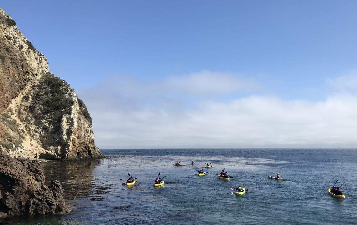 Kayakers explore Scorpion Anchorage at Santa Cruz Island, the largest of the Channel Islands off the coast of southern California.