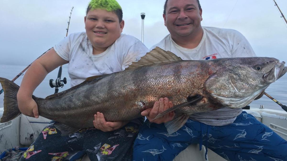 Marcos James Trejo, left, landed this 62.7-pound white seabass Sunday, along with his father, Mark Trejo, right, both of Grover Beach, while fishing out of the Port San Luis Boatyard.