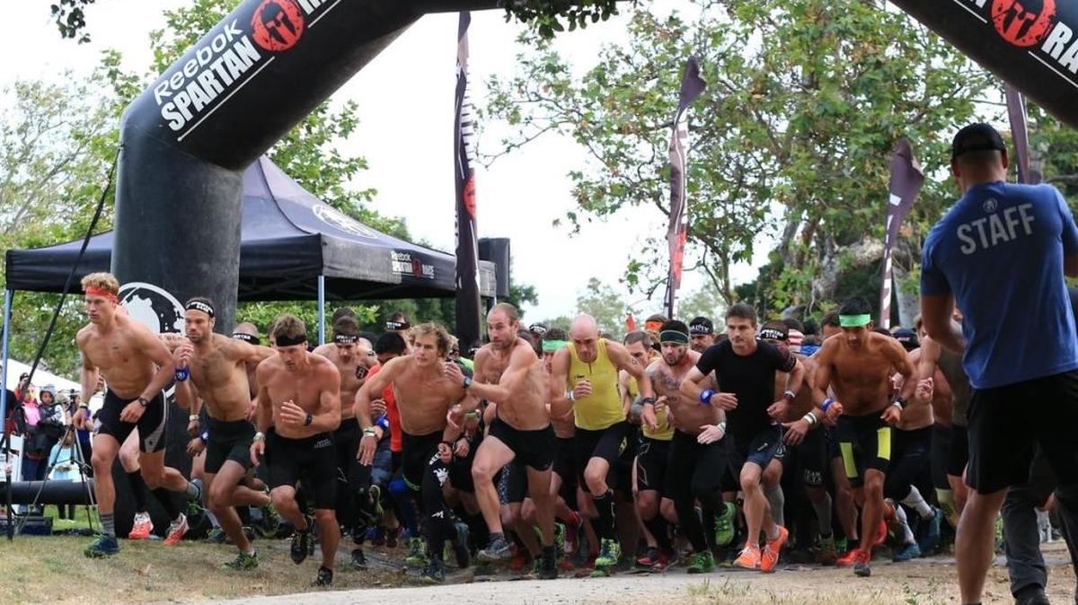 Male competitors take off from the starting line Saturday during the Monterey Super, a roughly 8-mile course consisting of more than 20 obstacles along the way.