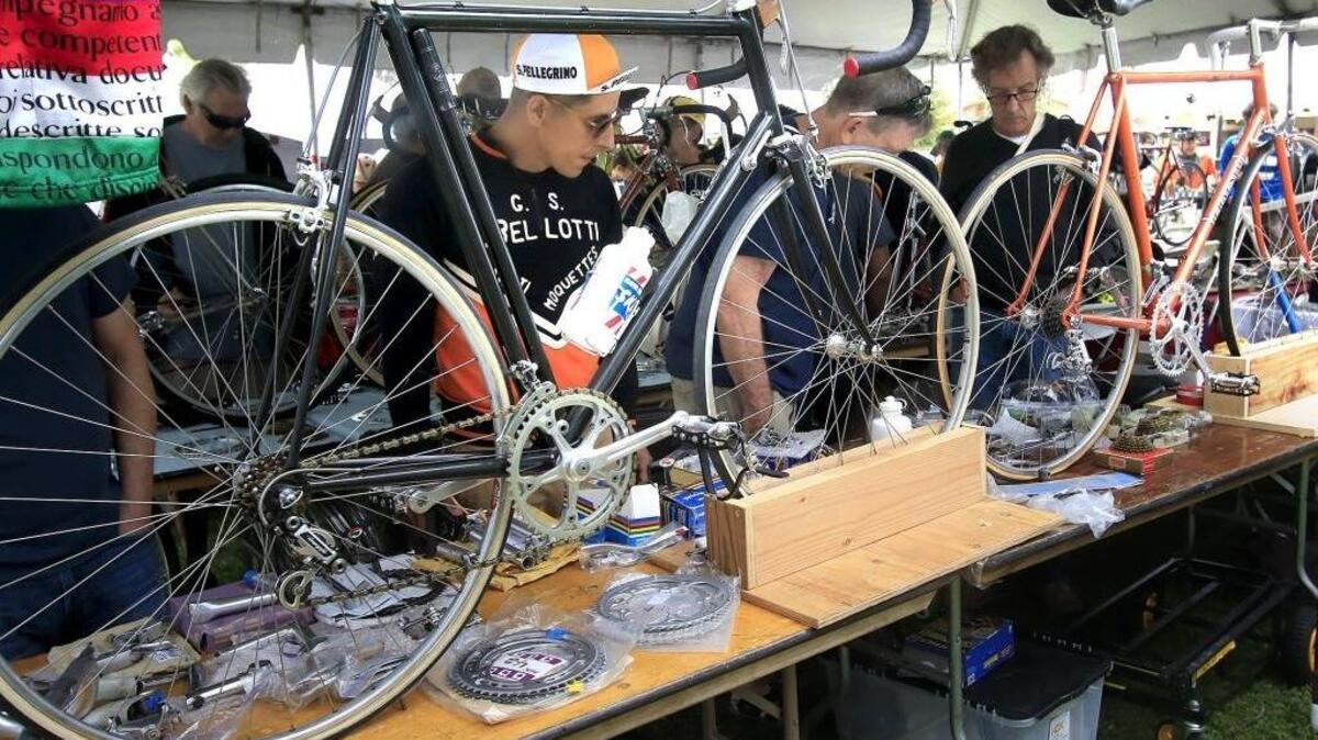 Bicycle enthusiasts check the old-style bicycles and parts at the bicycle fair at Eroica California in April 2016.