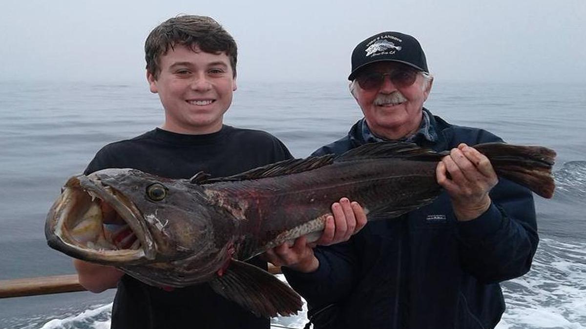 Fourteen-year-old Orcutt resident Cody Glynn, left, shows off his winning catch from Saturday’s John Rowley Biggest Baddest Lingcod Competition held by Virg’s Landing. Virg’s Bob Bodin, right, assists.