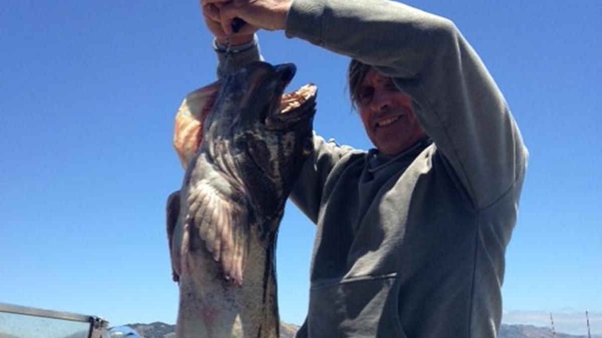 Santa Maria resident Daniel Hudson holds up the 25-pound lingcod he caught July 8 out of the Port San Luis boatyard.