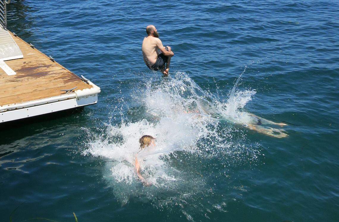 Hikers cool down with a refreshing swim at Prisoners Harbor after hiking Navy Road on Santa Cruz Island off the coast of southern California.