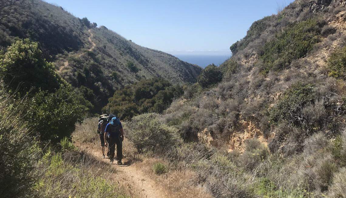 Kirk Barron follows his father-in-law, Pete Vaughan, up Del Norte Trail, which cuts through the canyons of Santa Cruz Island off the coast of southern California.