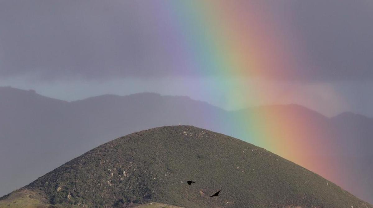 A Christmas Eve storm cast a rainbow behind Islay Hill in San Luis Obispo.