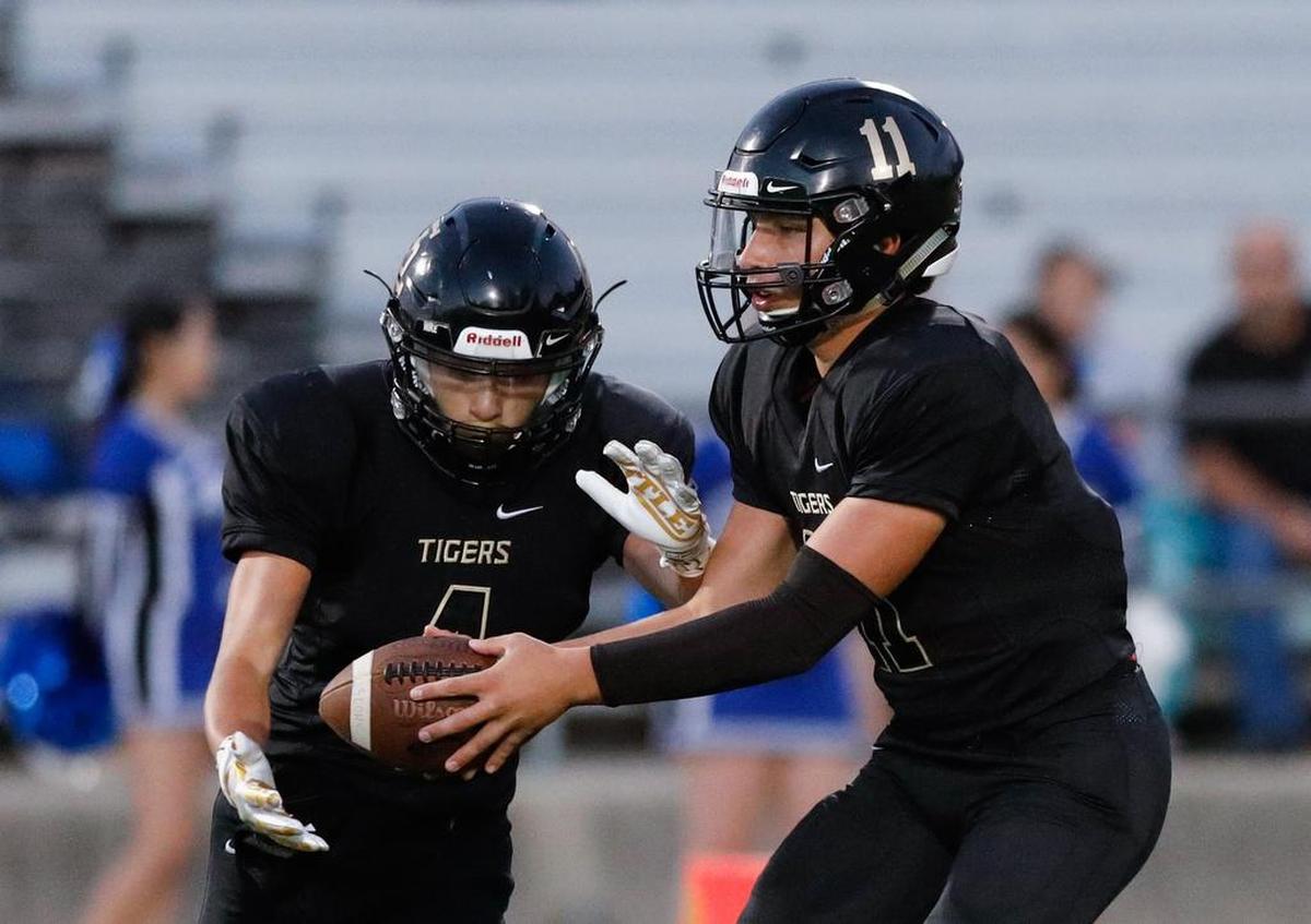 San Luis Obispo High School quarterback Emilio Corona hands off to Anthony Arroyo in a nonconference game Friday, September 21, 2018, against Hanford West.